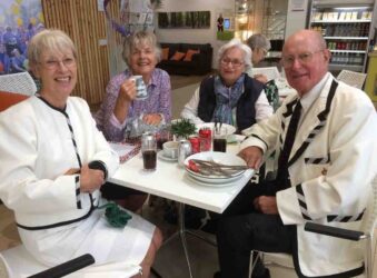 3 Females and 1 male sitting at a table
