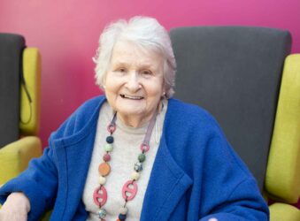Female wearing blue sitting in a chair