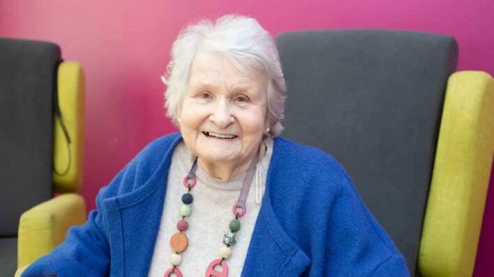 Female wearing blue sitting in a chair