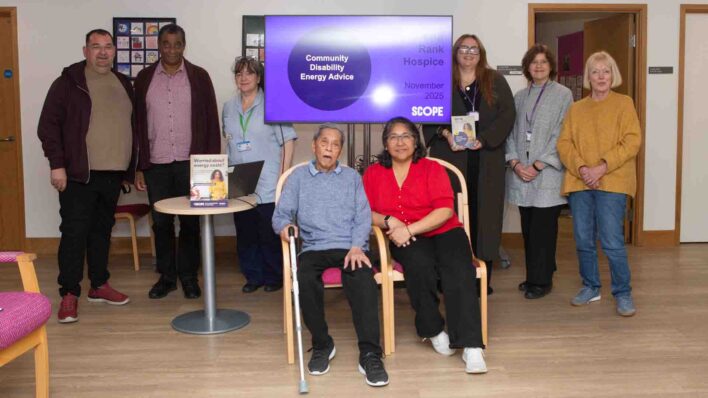 Group of adults around a TV