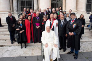 Group of adults dressed in red and black outside large building