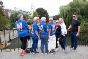 group of people on a bridge wearing blue tshirts
