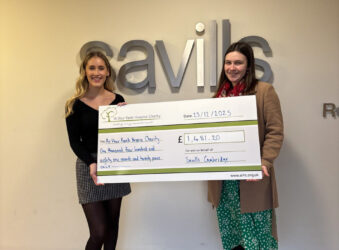 2 females holding a large cheque