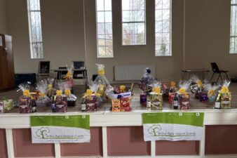 A row of Easter eggs and prizes are lined up on a table