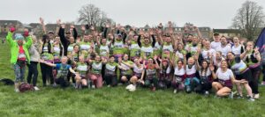 Group of male and females in green running tops