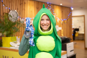 Female in green costume with medal