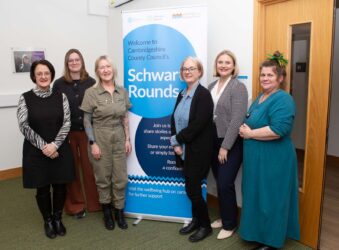 6 females with a blue banner