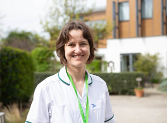 Female nurse smiling outside