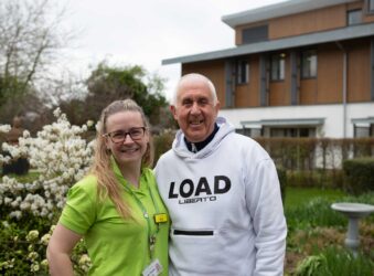 Female and male standing outside a building