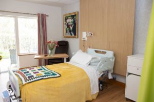 Bed in a room with a view to the garden