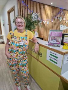 Female wearing bright dungarees