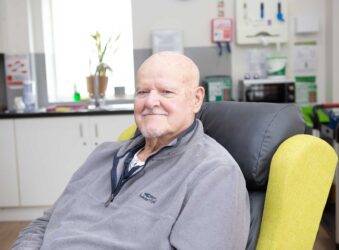 Male sitting in a chair looking at the camera