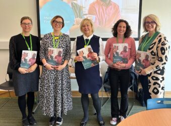Five females holding folders