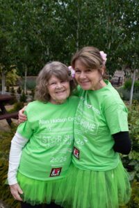 2 females wearing green t-shirts