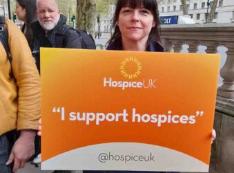 Female holding orange sign - I support hospices