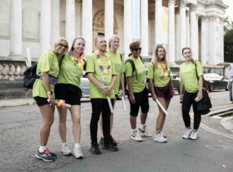 Male and females in green t-shirts outside Fitzwilliam Museum in Cambridge