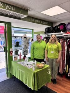 2 females wearing green next to a green table