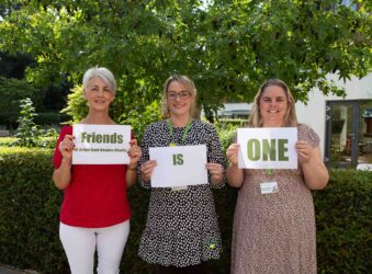 3 females holding signs