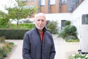 Male outside a white building