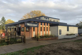 A pub with a 'welcome' sign outside