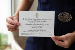 Nurse's hands holding an invitation