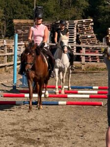Two females riding horses