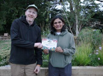 Male and female holding a certificate