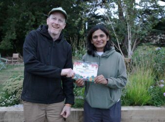 Male and female holding a certificate