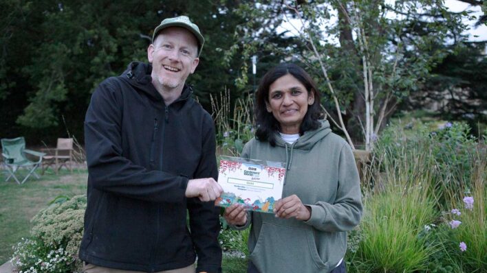 Male and female holding a certificate
