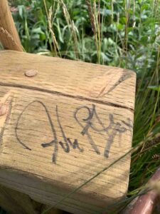 Signature on a wooden bench