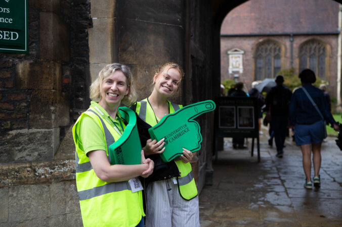 two females and green sign