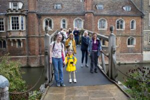 Adults and a child standing on a bridge