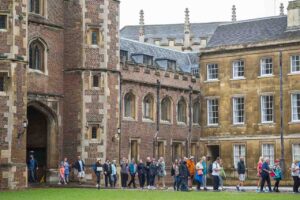 People walking around an old college