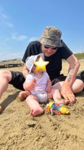 Male and baby on the beach 