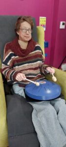 Female sitting in a chair with a drum
