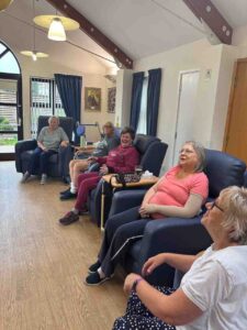 Adults sitting in chairs