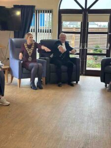 2 adults moving in chairs