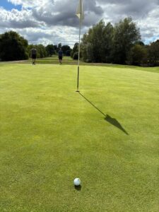 golf ball and flag on a golf course
